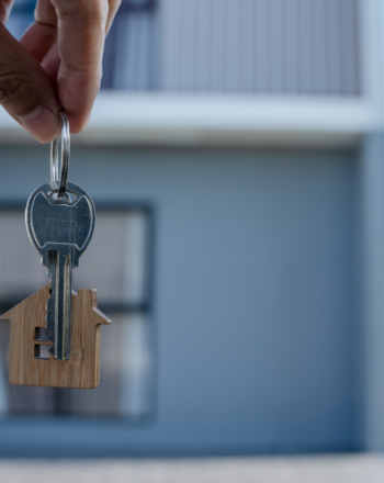 person holding keys in front of a house brrrr method
