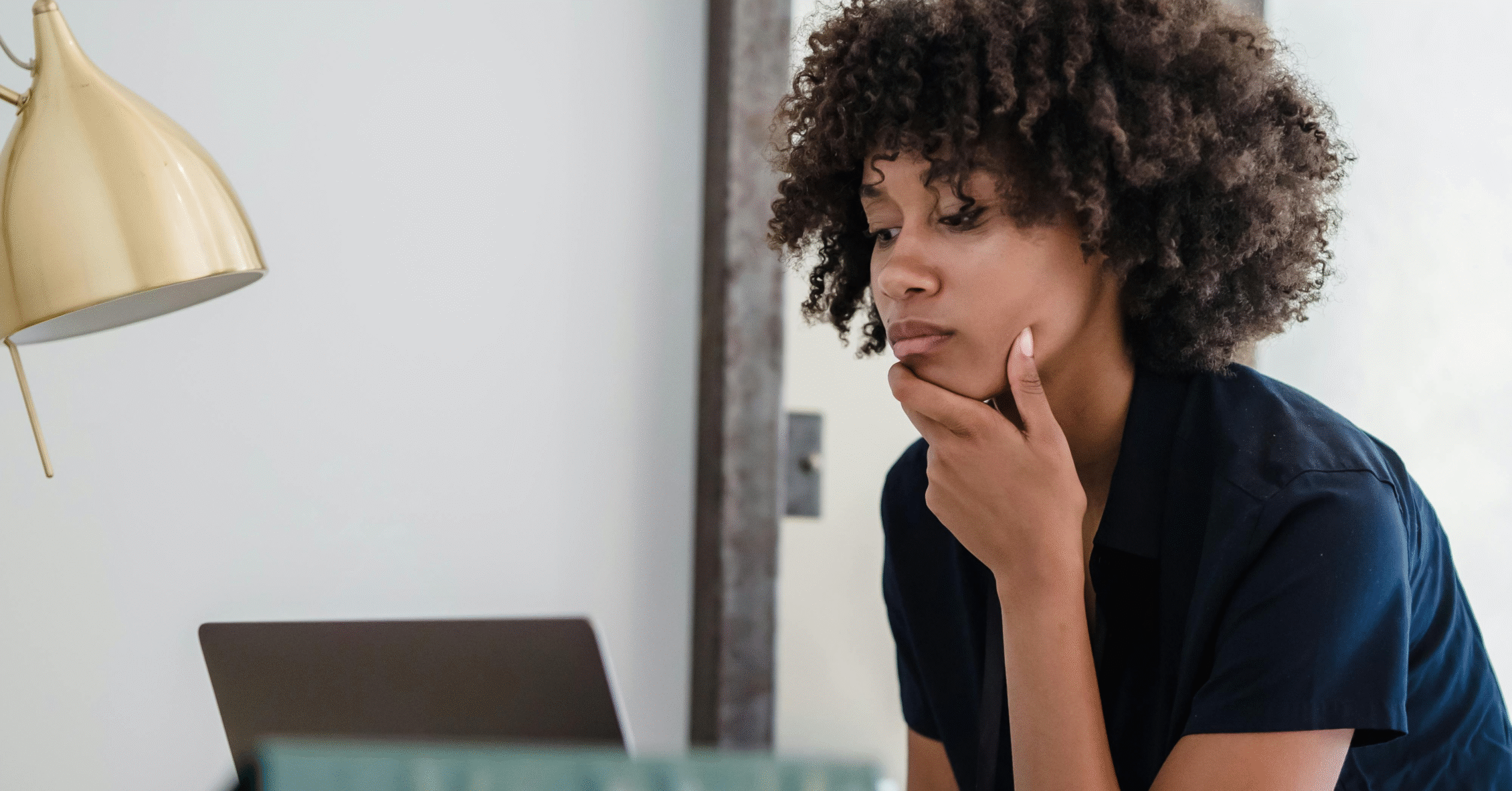 Woman thinking in front of computer