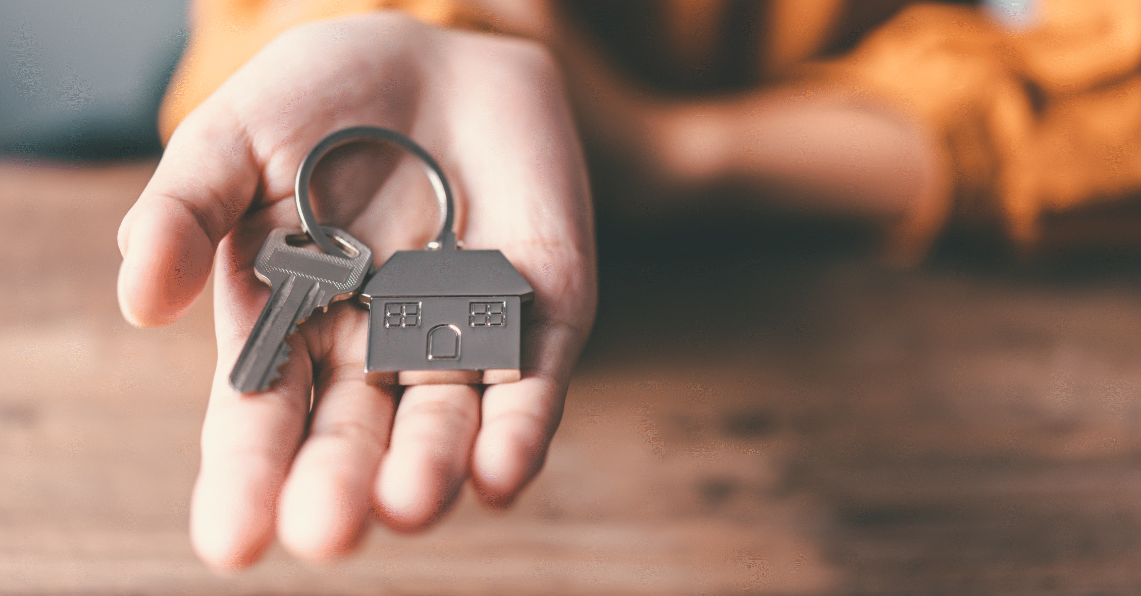 Hand holding house keys