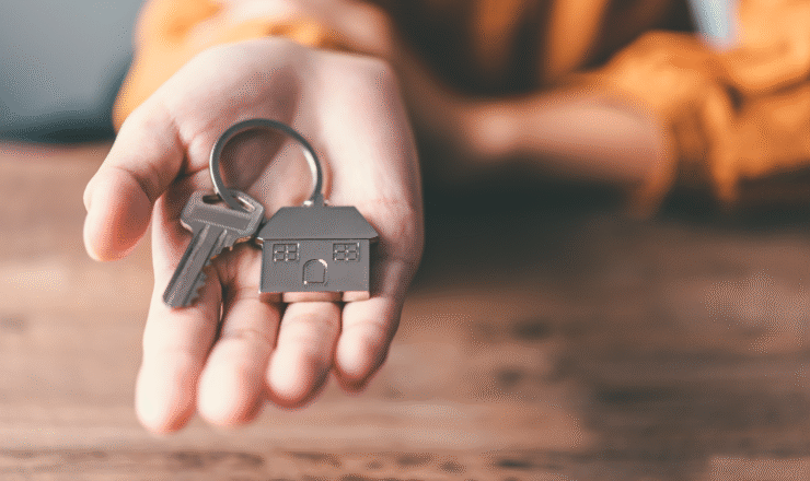 Hand holding house keys