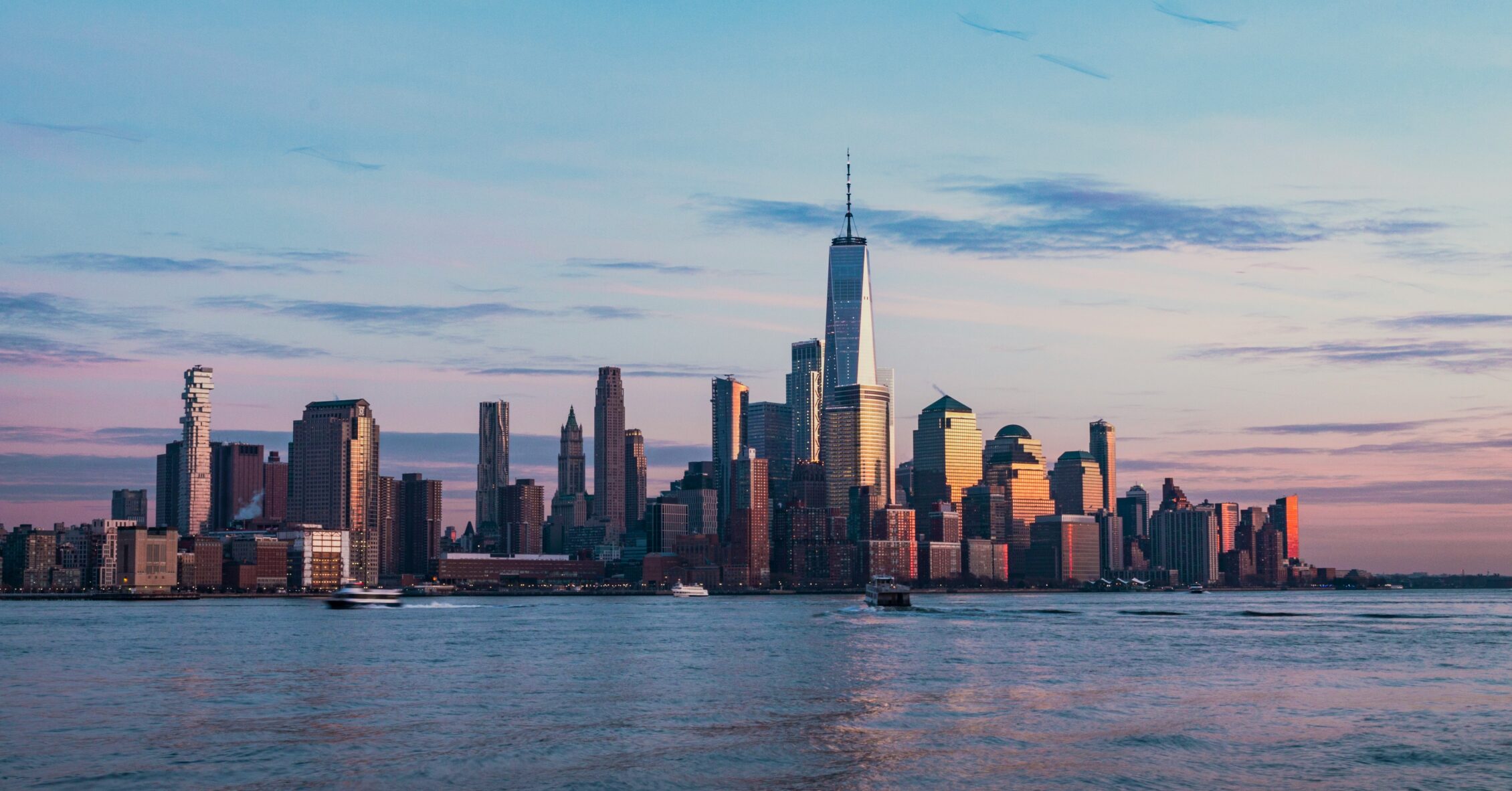 City skyline at sunrise representing the outlook for 2024 real estate investing