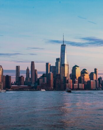 City skyline at sunrise representing the outlook for 2024 real estate investing